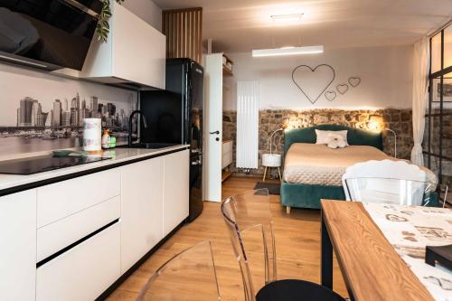 a kitchen and a bedroom with a bed in a room at La Chicca in pieno centro storico con SAUNA e Parcheggio gratuito in Udine