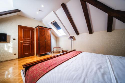 a bedroom with a large bed in a room at Boutique Hotel Kazbek in Dubrovnik