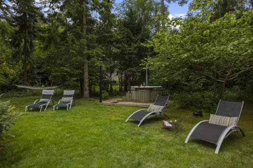 a group of chairs sitting in the grass at Holiday Home With A Wilderness Bath, Only 100 Meters From The Lovely Beach in Marielyst