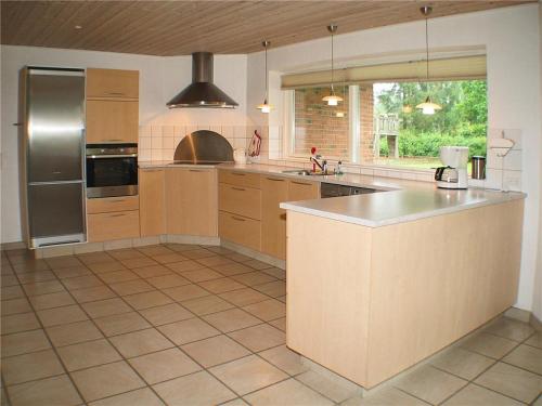 a kitchen with a stainless steel refrigerator and a counter at Nice Home In Hadsund W- in Hadsund