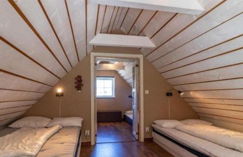a room with two beds in a attic at Awesome Home In Drottningsskär With 2 Bedrooms in Drottningskär