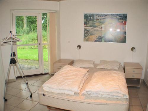 a bedroom with a bed with a camera on a tripod at Nice Home In Hadsund W- in Hadsund