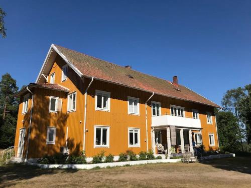 a large orange and white building in a yard at Beautiful Home In Torup With 13 Bedrooms in Torup