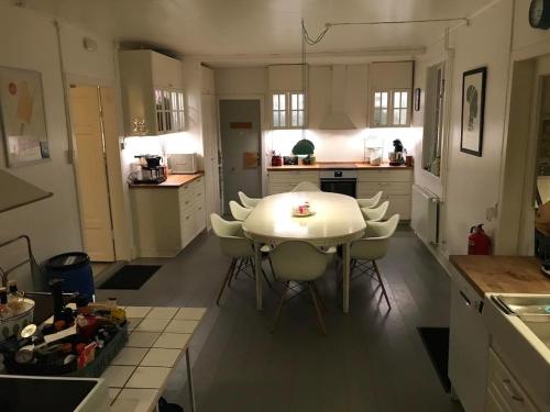 a kitchen with a white table and chairs at Beautiful Home In Torup With 13 Bedrooms in Torup