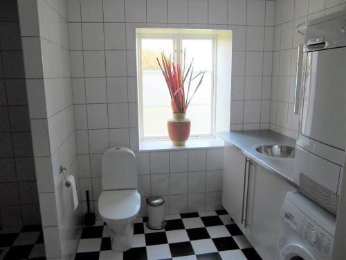 a bathroom with a toilet and a sink and a window at Amazing Home In Höganäs With 2 Bedrooms And Wifi in Höganäs