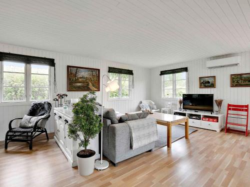 a living room with a couch and a tv at Amazing Home In Kirke Hyllinge With 3 Bedrooms And Wifi in Kirke-Hyllinge