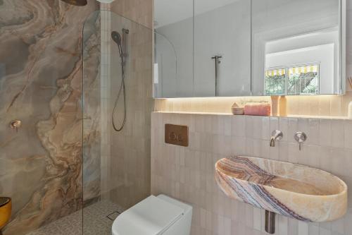a bathroom with a sink and a toilet at Belles Bondi Beach Apartments - 1 and 2 Bedroom Stays - 500m to beach in Sydney