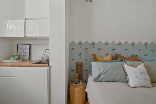 a bedroom with a bed with stars on the wall at Belles Bondi Beach Apartments - 1 and 2 Bedroom Stays - 500m to beach in Sydney
