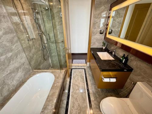 a bathroom with a shower and a sink and a tub at JB City CIQ-R&F Shopping Mall Apartment in Johor Bahru