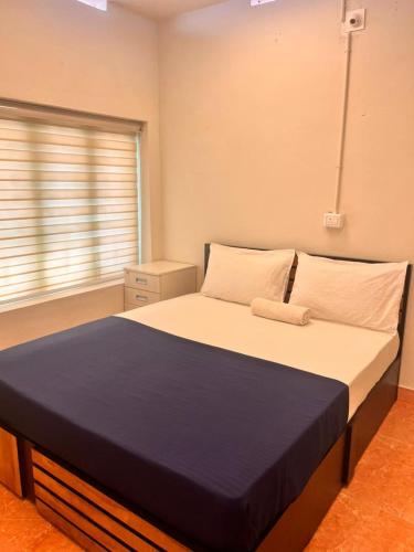 a large bed in a room with a window at VILLA CALATHEA Varkala in Varkala