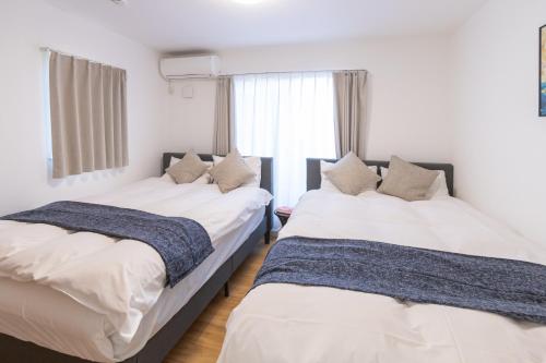 Postel nebo postele na pokoji v ubytování 住舎上新庄