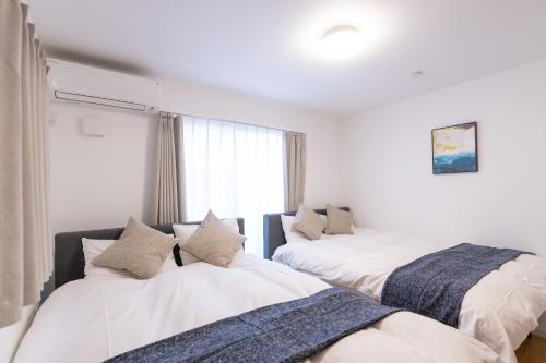 Postel nebo postele na pokoji v ubytování 住舎上新庄
