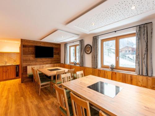 a dining room with a large wooden table and chairs at Farmhouse in Bramberg with Sauna & Ski Access in Dorf