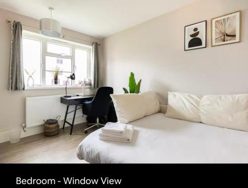 a bedroom with a white bed and a desk at Charming Double Room Near Richmond Park Kingston Gate in Kingston upon Thames