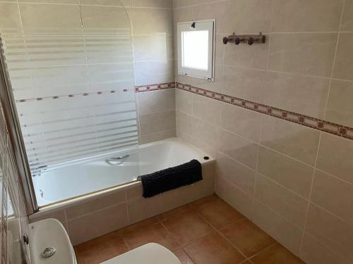 a bathroom with a bath tub and a toilet at Spacious villa with pool in Tarragona in Tarragona