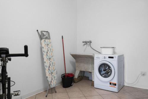 a laundry room with a washing machine and a sink at Borgo House In Florentine Hills With Pool in Fucecchio