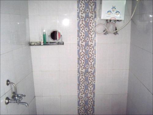 a shower in a bathroom with a shower curtain at Friends in Khajuraho in Khajurāho
