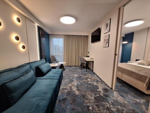 a living room with a couch and a bed at Hotel Gromada Łomża in Łomża