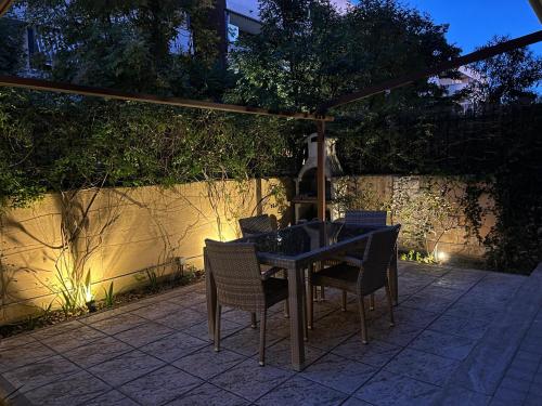 a table and chairs on a patio at night at Lele e Fede's Lodge & Relax in Rome