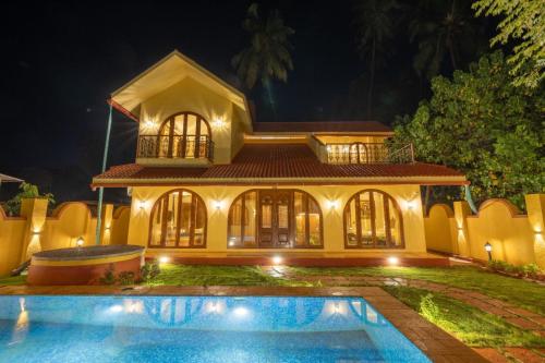 a house with a pool in front of it at night at Ishaan Holiday Home in Nagaon