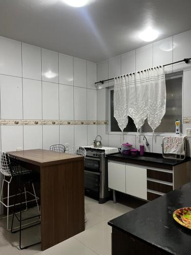 una cocina con una mesa y una encimera en Casa de praia com piscina, en Río Grande
