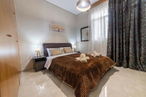 a bedroom with a bed with two towels on it at Valia's House in Kalabaka