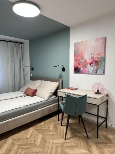 a bedroom with a bed and a desk and a chair at Tamaja 2 in Bielsko-Biała