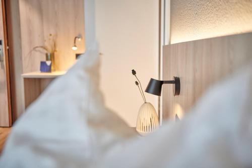 a lamp on a wall in a room at Hotel Balga Natur- und Bikehotel in Balgach