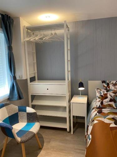 a bedroom with a bed and a white closet at Le Petit Remballais in Avessac