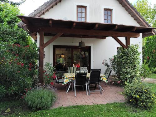 a patio with chairs and a table in front of a house at Sunshine Villa Fonyódliget in Fonyód