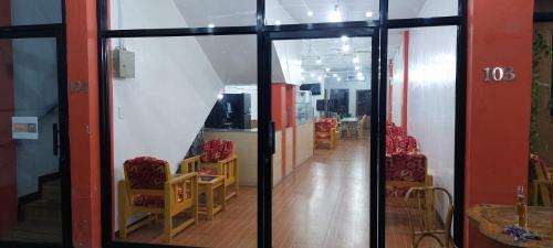 a hallway with chairs and tables in a building at SID'S Traveller's INN in General Santos