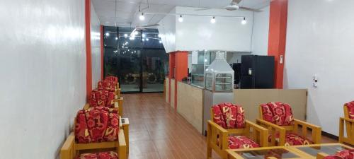 a row of chairs in a room with red chairs at SID'S Traveller's INN in General Santos