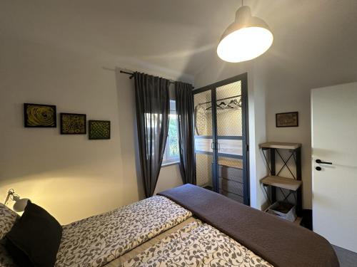 a bedroom with a bed and a window at Apartments Urban in Poreč
