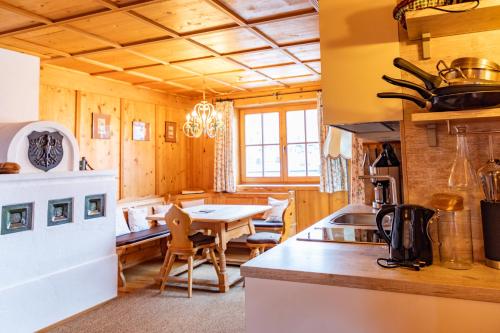 a kitchen with a table and a dining room at Appartements Kirchenwirt in Kirchberg in Tirol