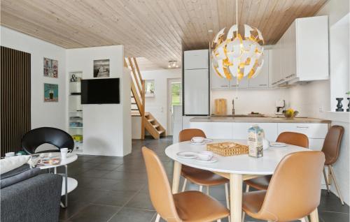 a kitchen and living room with a white table and chairs at Gorgeous Home In Hobro in Hobro