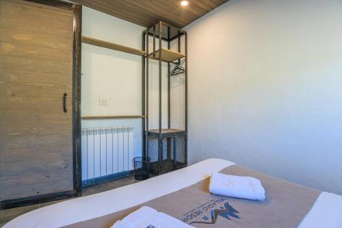 a bedroom with a bed and a window and a door at Villagio Resort in Zaarour in Zaarour