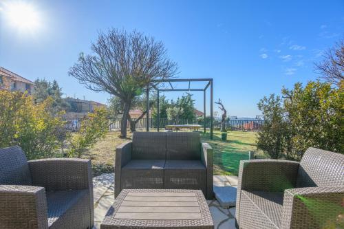 a patio with two chairs and a table and a playground at Villagio Resort in Zaarour in Zaarour