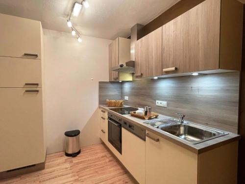 a small kitchen with a sink and a refrigerator at Chalet Zauberflöte in Radstadt