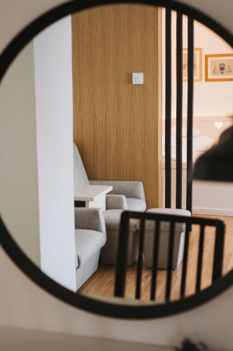 a view of a living room through a mirror at Tornácos Hotel - Hegykő in Hegykő