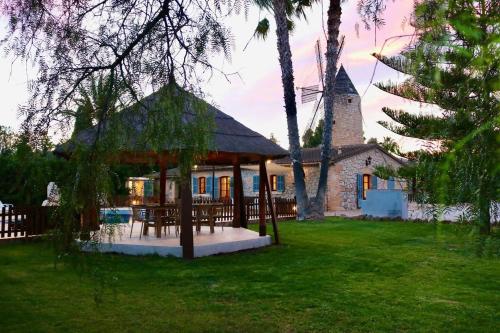 a house with a gazebo in a yard at Es Molí d'en Mig, jacuzzi, piscina y barbacoa in Consell
