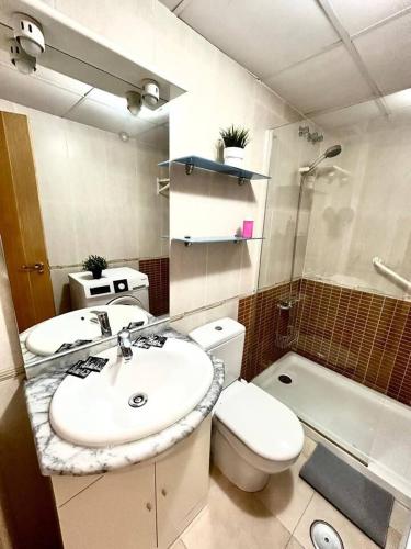 a bathroom with a sink and a toilet and a shower at Juan Carlos I - Más que apartamentos in El Castellar