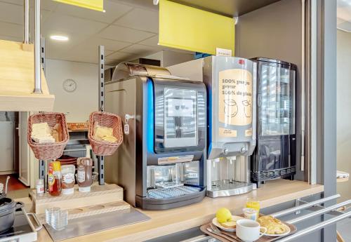 a kitchen with a coffee machine on a shelf at B&B HOTEL Brignoles in Brignoles