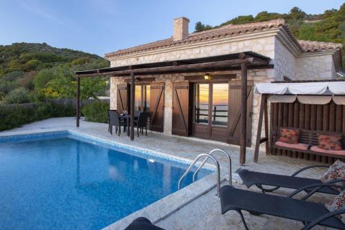 a villa with a swimming pool next to a house at Villa Ersi in Chortáta