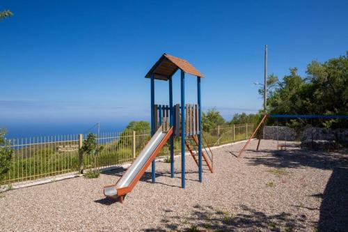 a playground with a slide in a park at Villa Ersi in Chortáta