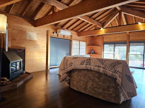 a bedroom with a bed and a fireplace in a room at Pet friendly NASU Royal Villa ペットと泊まれる広々貸切別荘 那須ロイヤルヴィラBBQ駐車4台OK in Nasu