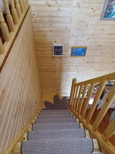 a staircase in a wooden cabin with a staircase at CABANA 365 in Braşov