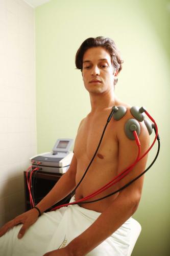 a shirtless man with headphones around his neck at Hotel Vivat in Moravske Toplice