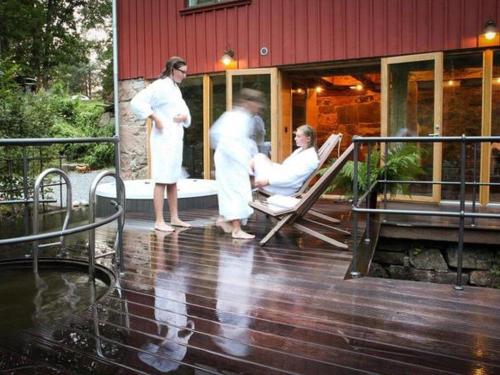 a group of people in white robes on a deck at Nice Home In Alingsås With 3 Bedrooms, Wifi And Sauna in Alingsås