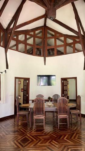 a dining room with a table and chairs at Ravintsara Wellness Hotel in Ambaro
