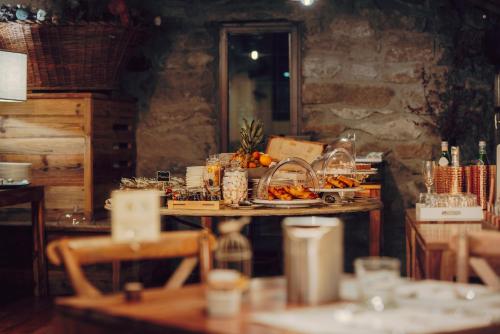a table with plates of food on top of it at Locanda La Brenva - Estella Hotel Collection & Experience in Courmayeur